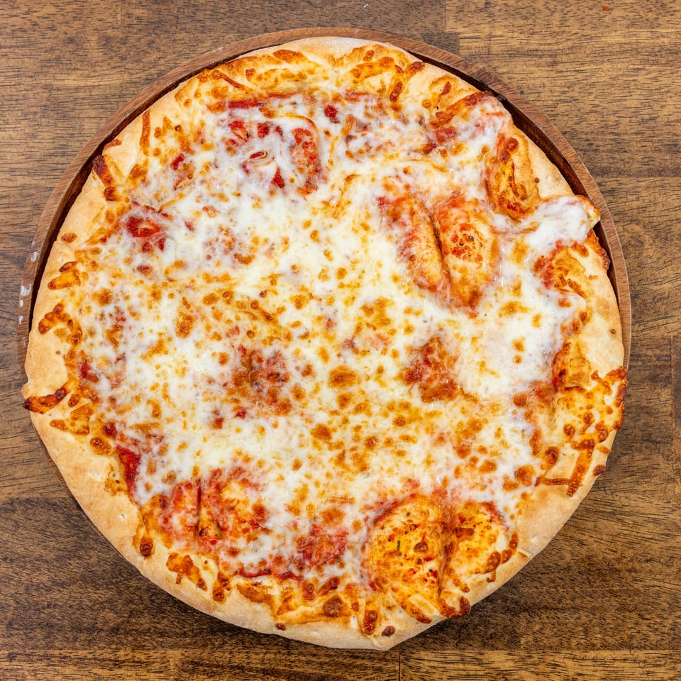 A whole cheese pizza with melted mozzarella and tomato sauce on a wooden serving board.